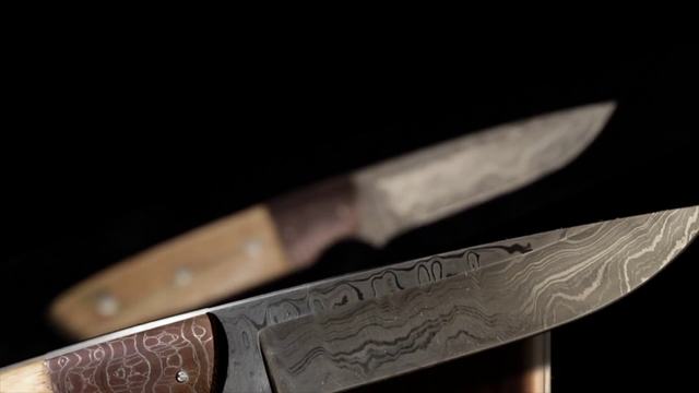 Light across a hand-forged Damascus blade, a frame from the demo reel