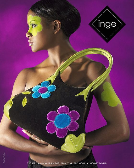 Fashion advertisement with a model holding a floral handbag
