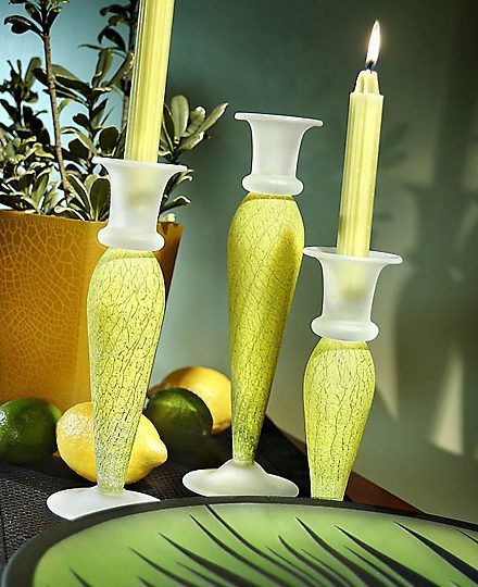 Green glass candlesticks with lit candles