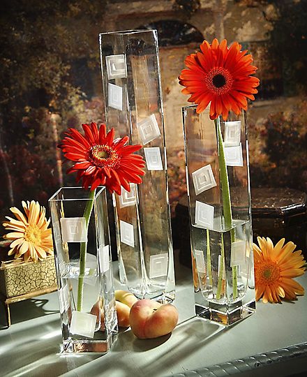Red gerbera daisies in tall glass vases
