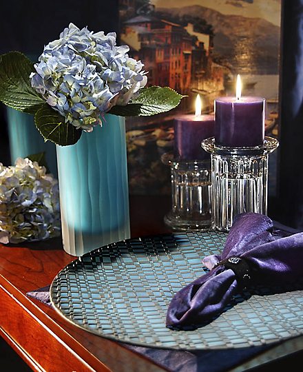 Hydrangeas, candles and a folded napkin on a table setting